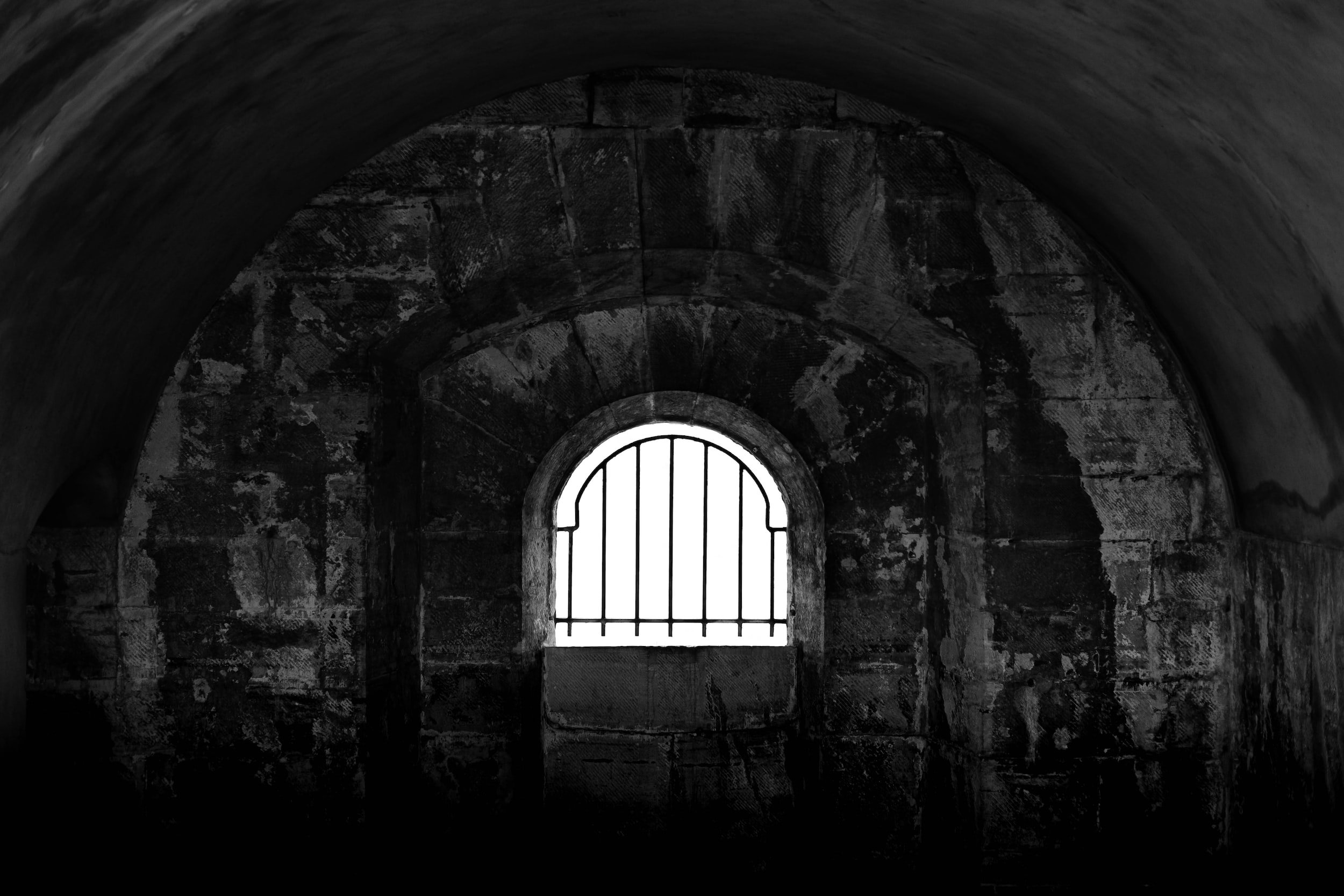 prison window with small bars dark and dreary