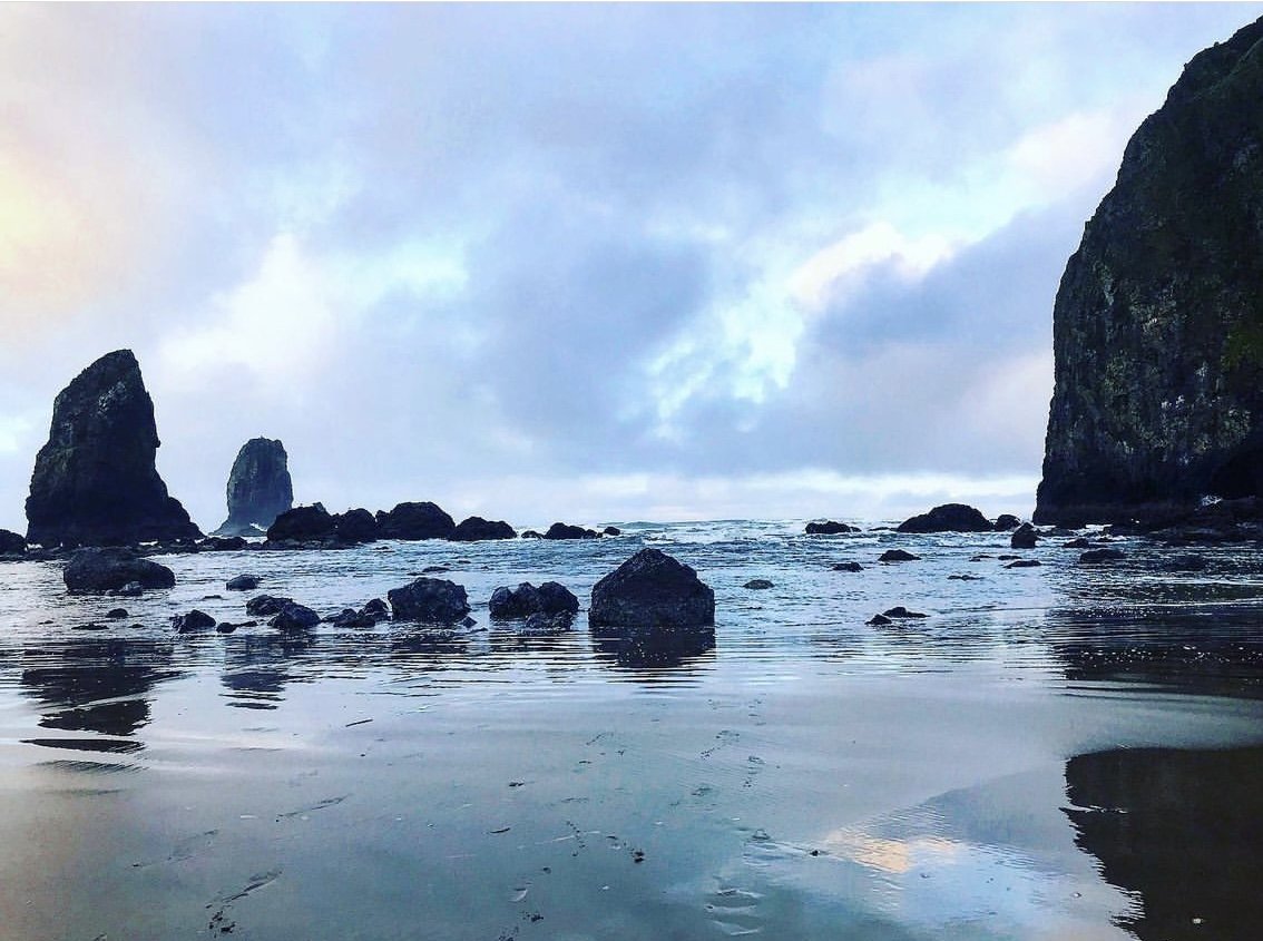 haystack rock cannon beach oregon. ocean and boulders with skyline
